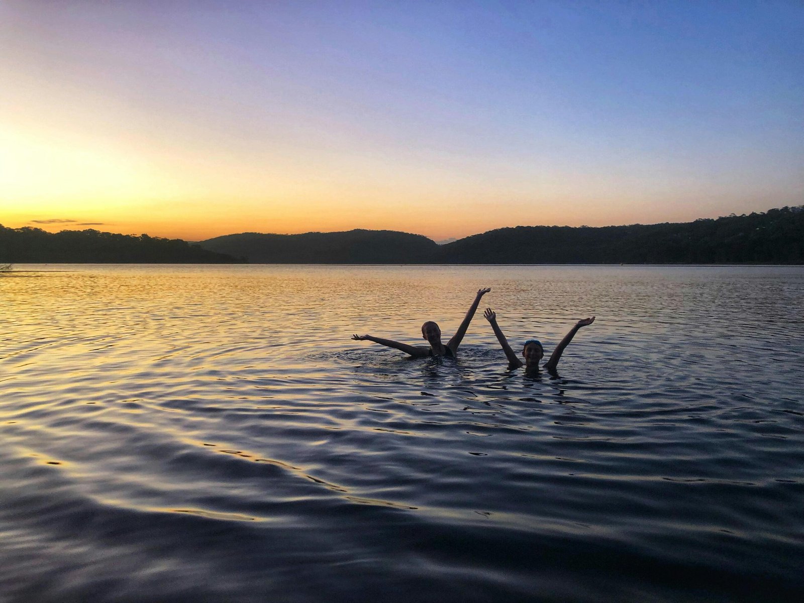 Woman swimming in a natural lake, wild swimming as an outdoor activity for women